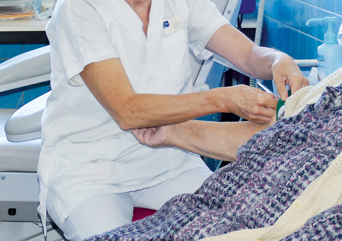 Photo d'une soignante qui pose une perfusion à une patiente